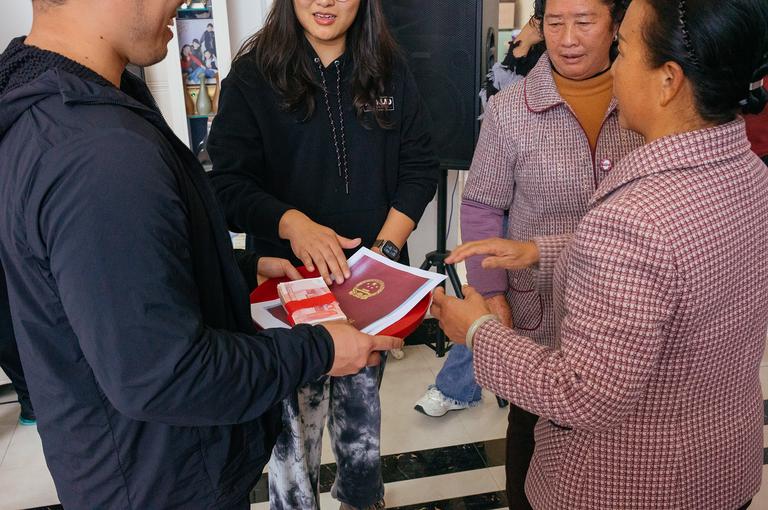 A portion of the bride price was given back to the groom as a gift to the couple. In addition, they also were given a house in the nearby large city of Kunming.