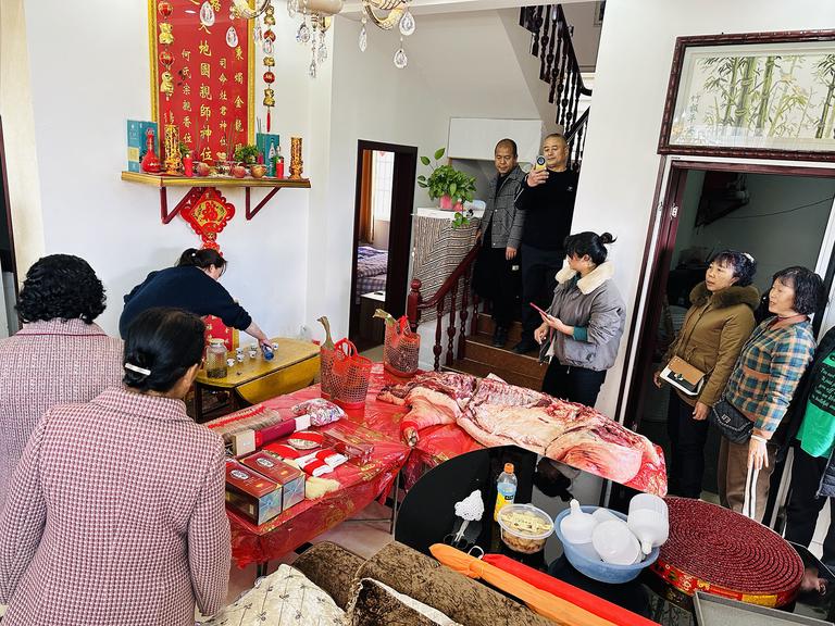 The family shrine in their living room with the consolidated bride price gifts as presented to the ancestors for review.