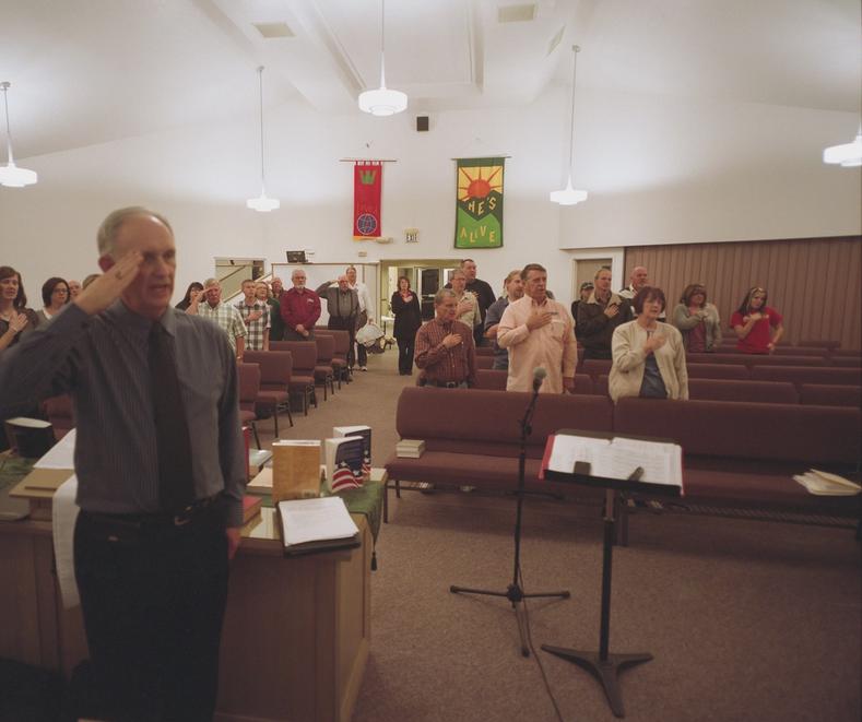 The Davis County Tea Party group held regularly meetings at local civic or religious buildings. Members here are pictured at their semi-regular location at the Mountain Road Evangelical Presbyterian Church. Each meeting was started with a prayer and was followed by the pledge of allegiance. The focus of meetings were varied but would usually include a review of a topic central to Tea Party doctrine.