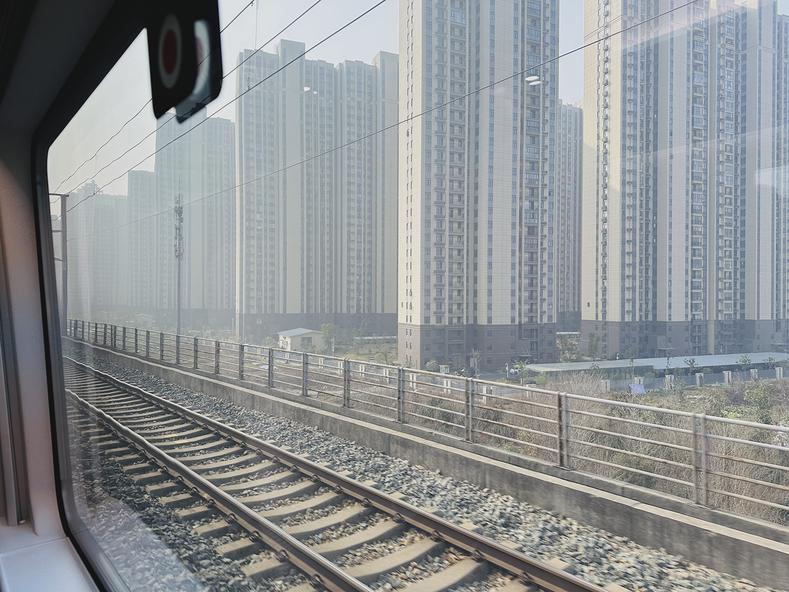 Watching the entire country of China zoom by my window at 350 km/h. These high rises in Wuhan were impressive.